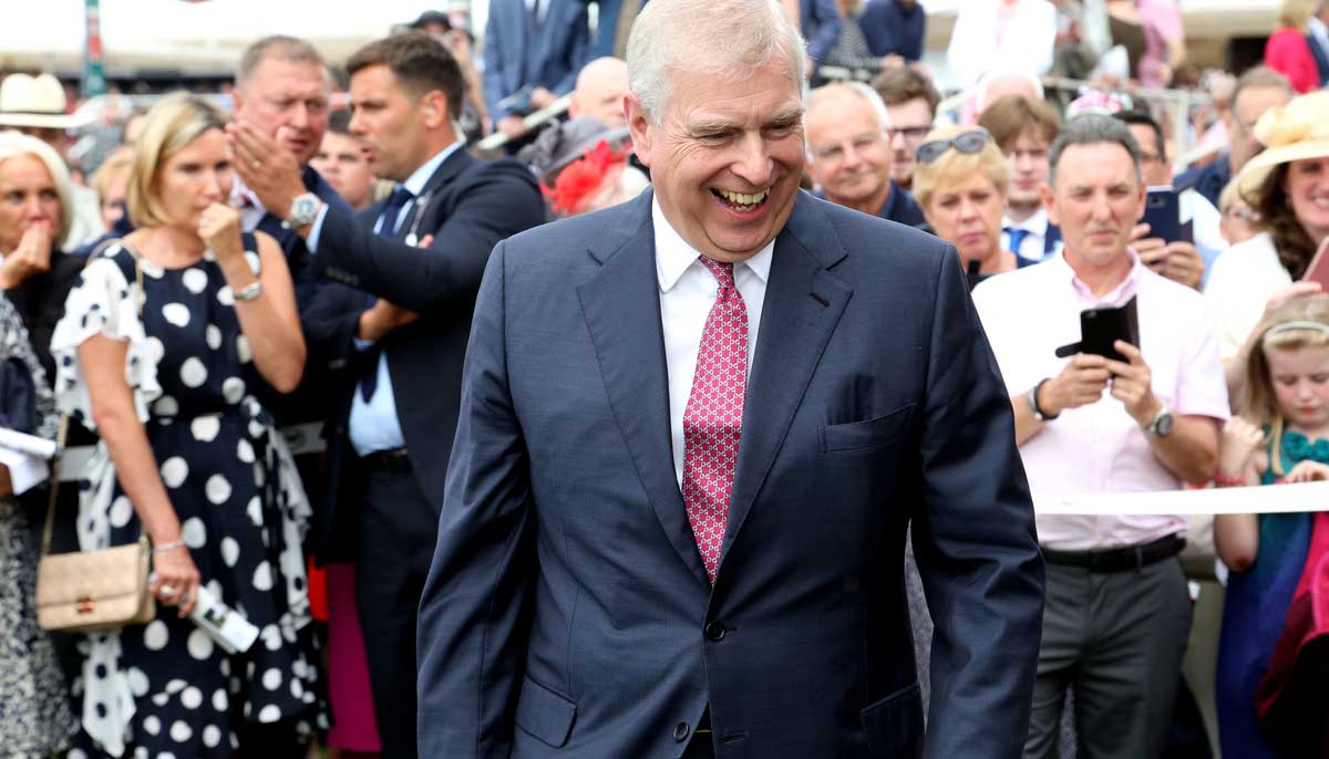 Prince Andrew photographed while laughing, mid-stride