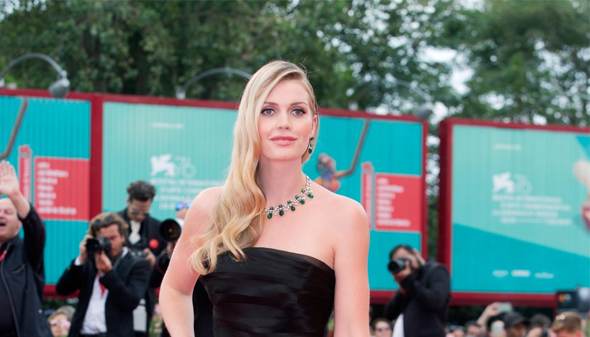 kitty spencer at a red carpet event wearing a black dress and elaborate necklace