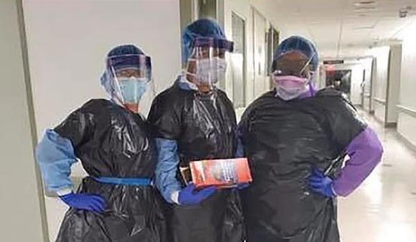 three nurses are shown wearing trash bags