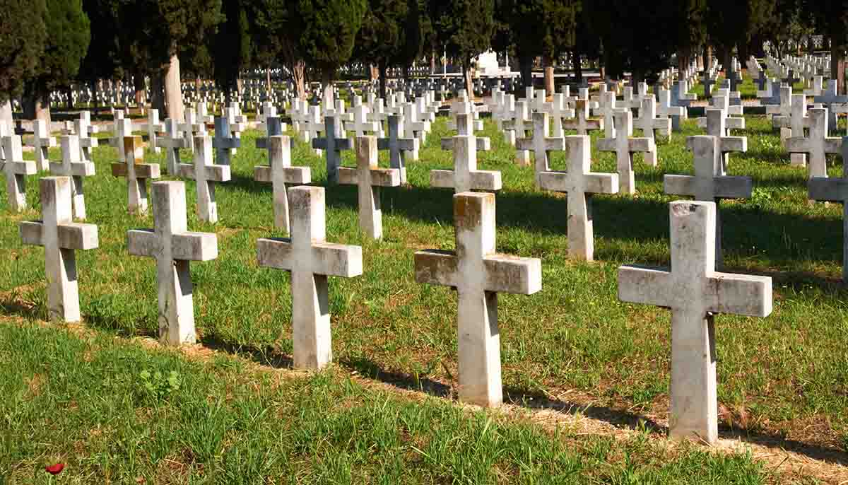 a line of crosses marking graves in an Italian WWI Military cemetery