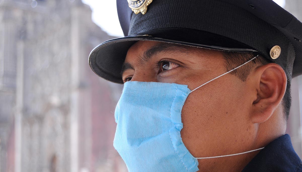 a police officer wears a face mask