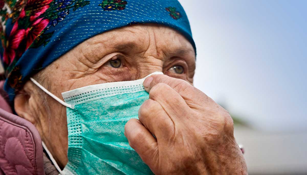 an older woman wears a medical mask amid coronavirus spread
