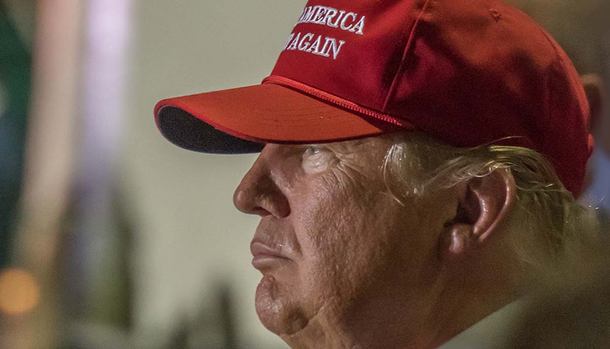 President Trump wears a MAGA hat during a rally