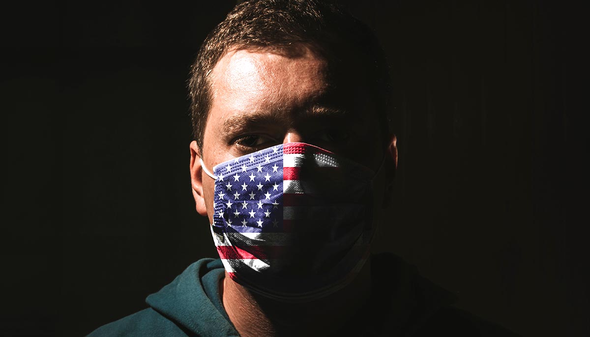 man wears covid 19 mask with american flag on it