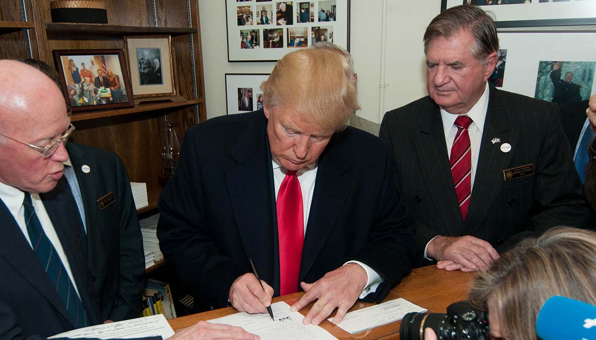 Trump signs paperwork