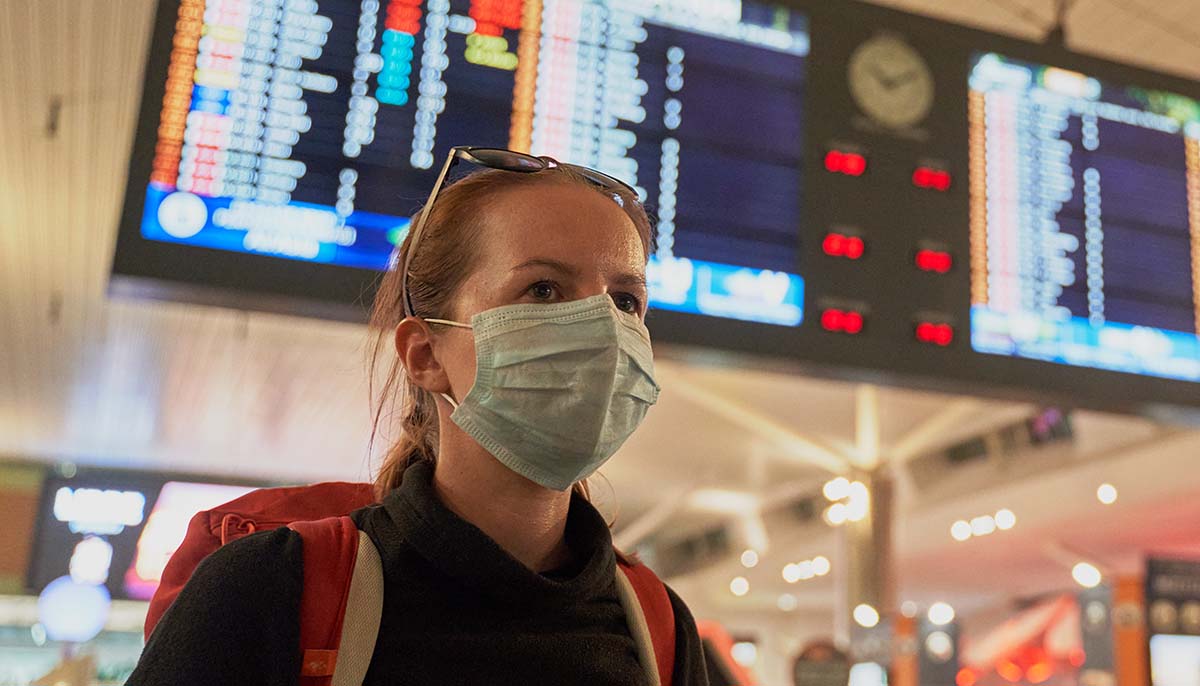 woman wears face mask at airport