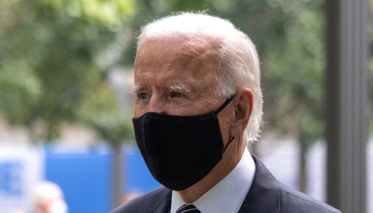 Joe Biden wears a black face mask outside