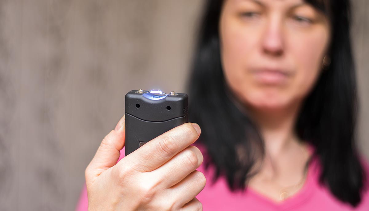 a woman with a taser in her hand