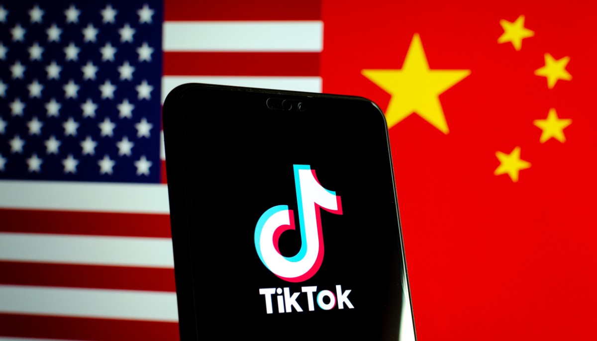 the tiktok app against an american and chinese flag