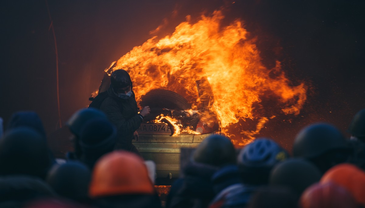 a statue on fire during protests