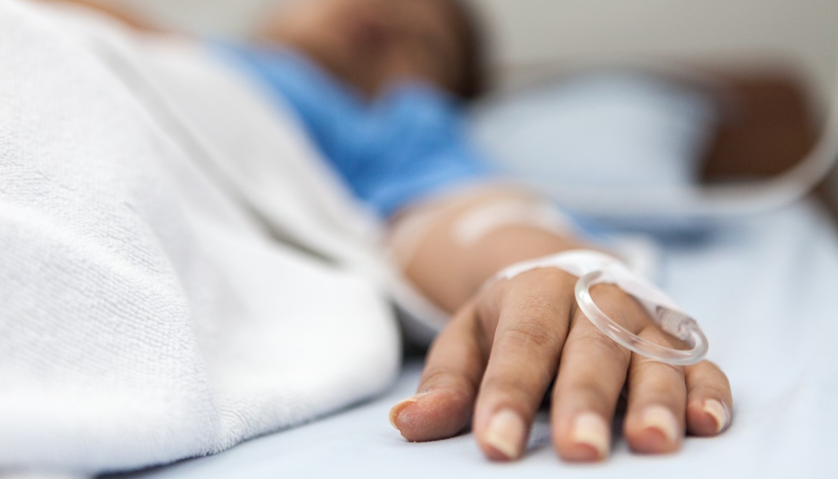 a man laying in a hospital bed