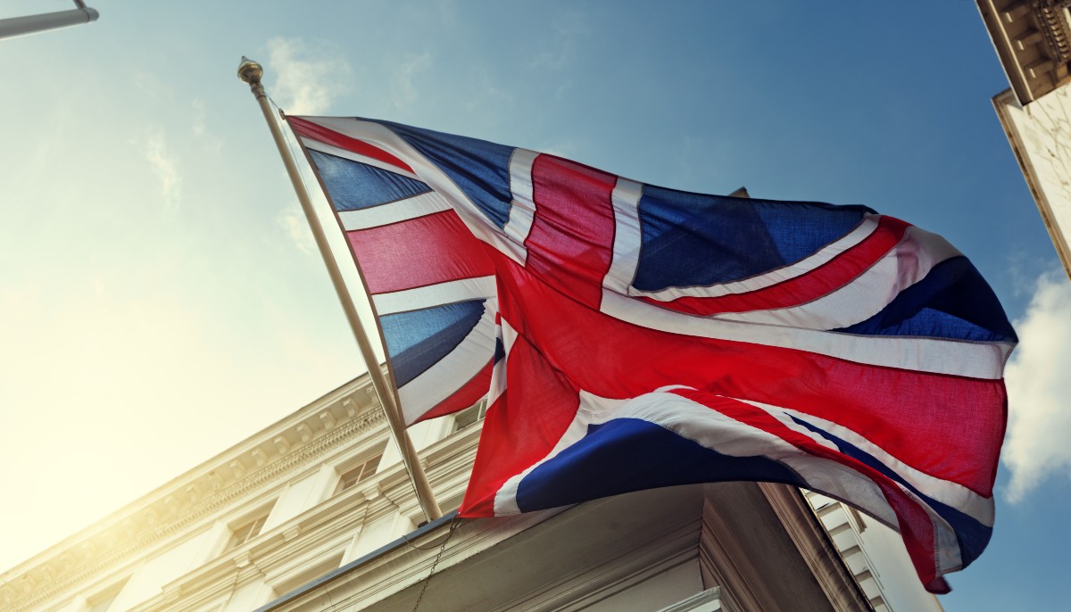 a uk flag flying on a building