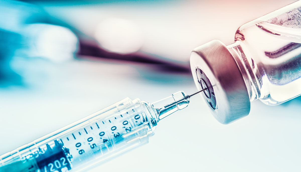 close up of a vaccine and syringe