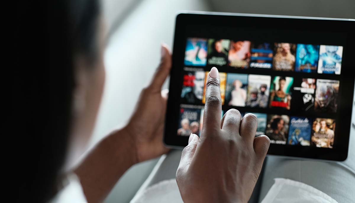 woman browsing Netflix on a tablet